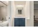 Small bathroom with a blue vanity, tiled walls, and a window at 1180 Yosemite St # 104, Denver, CO 80220