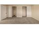 Bedroom featuring two double closets and neutral carpeting at 1180 Yosemite St # 104, Denver, CO 80220