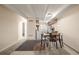 View of kitchen from dining area with wooden table and chairs and carpeted floors at 1180 Yosemite St # 104, Denver, CO 80220