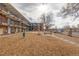 Building exterior showing a courtyard with picnic tables and a mulch yard at 1180 Yosemite St # 104, Denver, CO 80220