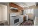 Efficient kitchen with wood cabinets and modern appliances at 1180 Yosemite St # 104, Denver, CO 80220