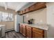 Kitchen with wooden cabinets, granite countertops, stainless steel appliances, and a bright window at 1180 Yosemite St # 104, Denver, CO 80220