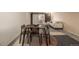 Living room with modern furniture and a wooden dining table and chairs in the foreground at 1180 Yosemite St # 104, Denver, CO 80220