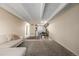 Spacious living room area featuring a couch, carpeted floors, and a kitchen and dining area at 1180 Yosemite St # 104, Denver, CO 80220
