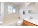 Clean bathroom with updated vanity and bathtub shower combo at 1056 N Marion St # 204, Denver, CO 80218