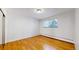 Bright bedroom featuring hardwood floors and a large window at 1056 N Marion St # 204, Denver, CO 80218