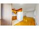 Open kitchen with wood cabinets and access to living room at 1056 N Marion St # 204, Denver, CO 80218