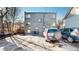 Rear parking area with two cars and building view at 1056 N Marion St # 204, Denver, CO 80218