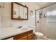 Bathroom featuring a vanity with a wood cabinet and a white tile shower at 3751 W 85Th Ave, Westminster, CO 80031