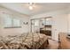Bedroom featuring large mirrored closet doors, carpet, and a ceiling fan at 3751 W 85Th Ave, Westminster, CO 80031