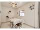 Bright dining room with a window, ceiling fan, and a table with white chairs at 3751 W 85Th Ave, Westminster, CO 80031