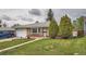 Beautiful home showcasing a well-kept lawn, brick facade, and neatly trimmed evergreen trees at 3751 W 85Th Ave, Westminster, CO 80031