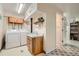 Functional laundry room with washer, dryer, sink, and convenient shelving for storage at 3751 W 85Th Ave, Westminster, CO 80031