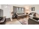 Spacious living room featuring a couch, accent chair, area rug and natural light at 3751 W 85Th Ave, Westminster, CO 80031