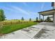 Spacious backyard with a well-manicured lawn, a covered patio, and a charming wooden fence at 6513 Dry Fork Cir, Frederick, CO 80516
