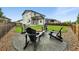 Well-maintained backyard featuring a stone firepit area with Adirondack chairs and expansive green lawn at 6513 Dry Fork Cir, Frederick, CO 80516