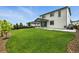Open backyard featuring large grassy area, patio, and privacy fence, ideal for outdoor activities at 6513 Dry Fork Cir, Frederick, CO 80516
