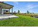 Picture of the patio with steps leading down to a spacious backyard with a neat lawn and wooden fence at 6513 Dry Fork Cir, Frederick, CO 80516