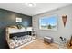 Cozy bedroom with a unique wall design, bunk bed, and a sunlit window view at 6513 Dry Fork Cir, Frederick, CO 80516