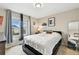 Bedroom featuring large window, a black bed frame and small black nightstand at 6513 Dry Fork Cir, Frederick, CO 80516