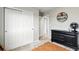 Bedroom featuring closet with sliding doors, dark wood dresser and carpet at 6513 Dry Fork Cir, Frederick, CO 80516