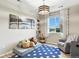 Cozy bedroom with playful decor, a comfortable armchair, and a large window offering natural light at 6513 Dry Fork Cir, Frederick, CO 80516