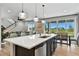Bright open kitchen with a large island, stainless steel appliances, and modern pendant lighting at 6513 Dry Fork Cir, Frederick, CO 80516