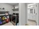 Efficient laundry room with modern washer/dryer set and shelving, leading to the bathroom at 6513 Dry Fork Cir, Frederick, CO 80516