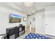 Inviting living room with modern furnishings, a mounted TV, and a view into the hallway at 6513 Dry Fork Cir, Frederick, CO 80516