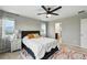 Main bedroom features large windows with natural light, ceiling fan and en suite bathroom at 6513 Dry Fork Cir, Frederick, CO 80516