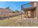 Backyard featuring a wooden fence, under-deck patio and stairs leading to a raised deck at 861 Circle Rd, Palmer Lake, CO 80133