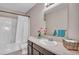 Bathroom with a shower-tub combo, tile flooring, and a vanity with a large mirror at 861 Circle Rd, Palmer Lake, CO 80133
