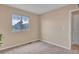 Bedroom with neutral carpet, window view, and a white door to the side at 861 Circle Rd, Palmer Lake, CO 80133