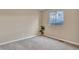 Bedroom featuring neutral carpet, a window view, and a potted plant at 861 Circle Rd, Palmer Lake, CO 80133