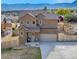 Two-story stucco house with a two-car garage, fenced yard and mountain views at 861 Circle Rd, Palmer Lake, CO 80133