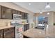 Spacious kitchen features dark cabinetry, stainless steel appliances, and granite countertops at 861 Circle Rd, Palmer Lake, CO 80133