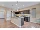 Kitchen features an island with granite countertops, stainless appliances, and dark cabinets at 861 Circle Rd, Palmer Lake, CO 80133
