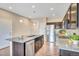 Bright kitchen featuring granite counters, stainless steel appliances, and dark cabinetry at 861 Circle Rd, Palmer Lake, CO 80133