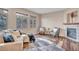 Cozy living room featuring wood-look floors, large windows, and a stone fireplace at 861 Circle Rd, Palmer Lake, CO 80133