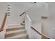 Carpeted staircase with wood railings leads to the upper level of the home at 861 Circle Rd, Palmer Lake, CO 80133