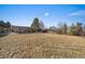 View of expansive backyard including a backyard patio, lawn, and wood fence at 7110 S Cherry Dr, Centennial, CO 80122