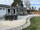 A backyard patio shows an outdoor dining set and furniture perfect for enjoying the outdoor scenery at 7110 S Cherry Dr, Centennial, CO 80122