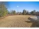 Backyard with spacious lawn, wood fence, landscaping and adjacent patio at 7110 S Cherry Dr, Centennial, CO 80122