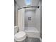 Cozy bathroom featuring a tub with shower and skylight at 7110 S Cherry Dr, Centennial, CO 80122