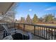 Outdoor wooden deck with chairs overlooking a large backyard at 7110 S Cherry Dr, Centennial, CO 80122