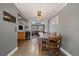 A farmhouse dining table with views to living space and kitchen at 7110 S Cherry Dr, Centennial, CO 80122