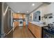 Bright kitchen with stainless steel appliances, wood cabinets, dark backsplash, and hardwood floors at 7110 S Cherry Dr, Centennial, CO 80122