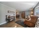 Cozy living room featuring hardwood floors, a stylish rug, and comfortable leather seating at 7110 S Cherry Dr, Centennial, CO 80122