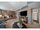 Cozy living room featuring a brick fireplace and large TV at 7110 S Cherry Dr, Centennial, CO 80122