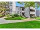 Manicured lawn leads to the unit's entry, showcasing the building's modern design at 6410 S Dayton St # I05, Englewood, CO 80111